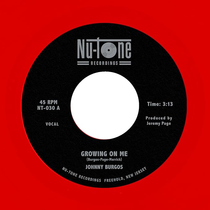 Black and white 45 RPM record label with text: "Growing On Me" by Johnny Burgos.