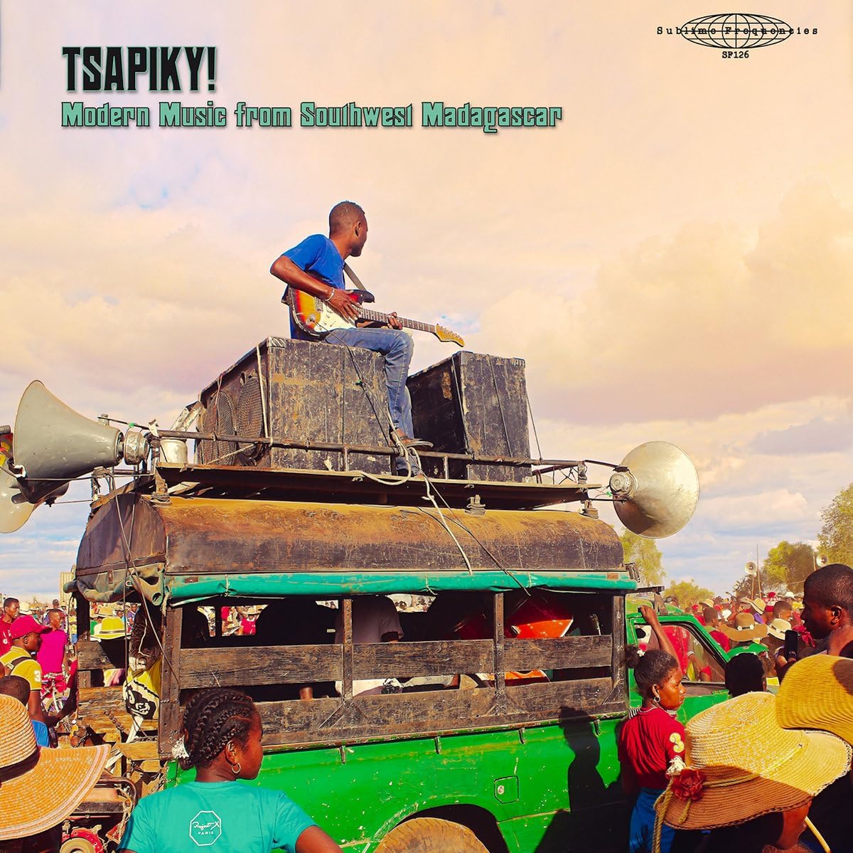 Vinyl album cover featuring a musician playing atop a decorated truck.