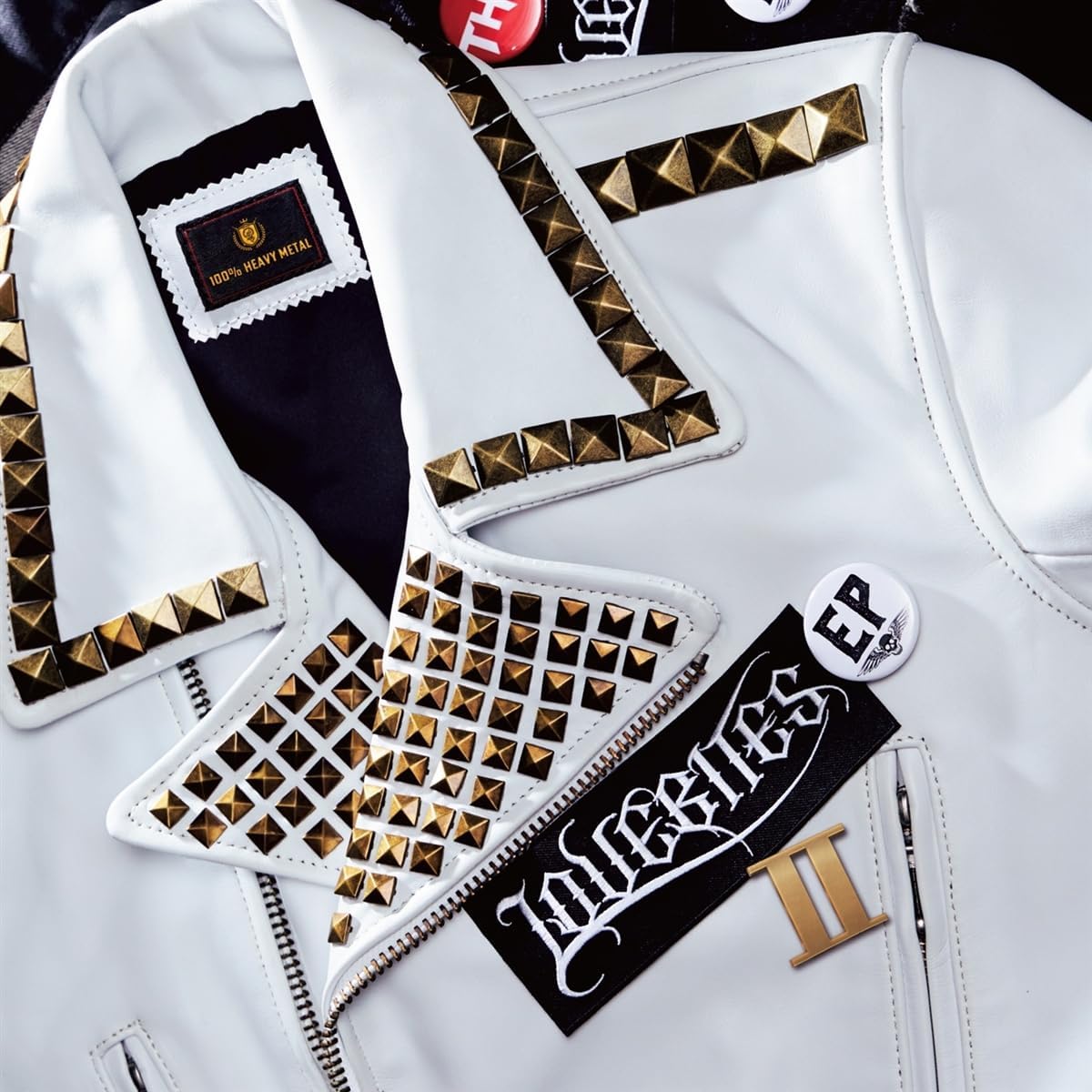 CDs and a jacket with gold spikes, close-up view.