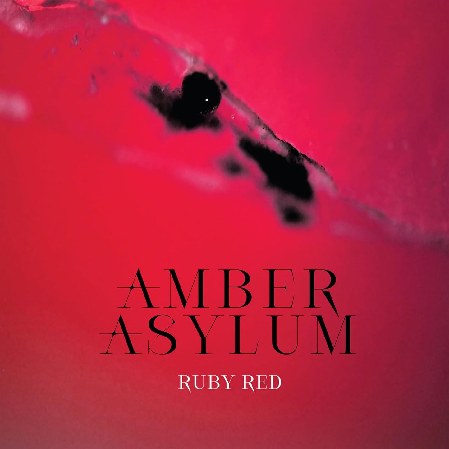 Red album cover with silhouetted figure and band/album title text.