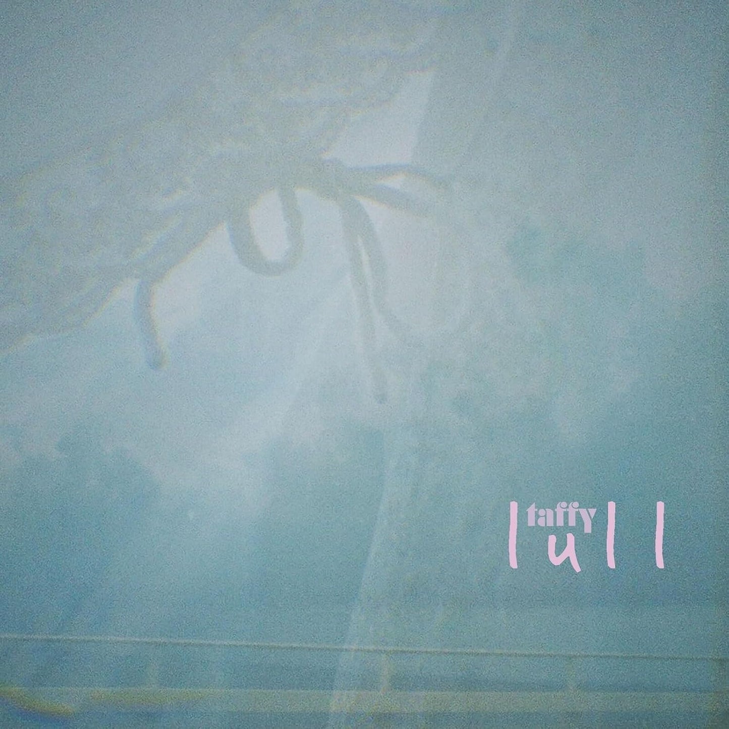 Pale blue album cover with a blurred, ghostly tree and text “taffy lull”.