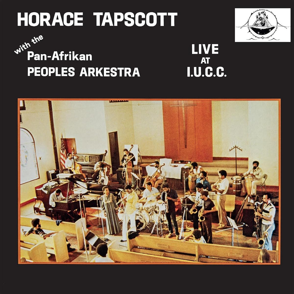 Horace Tapscott and orchestra performing live on a stage with audience.
