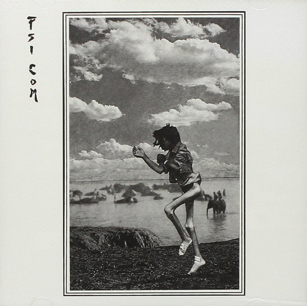 Black and white photo of a person running on a beach, cloudy sky.