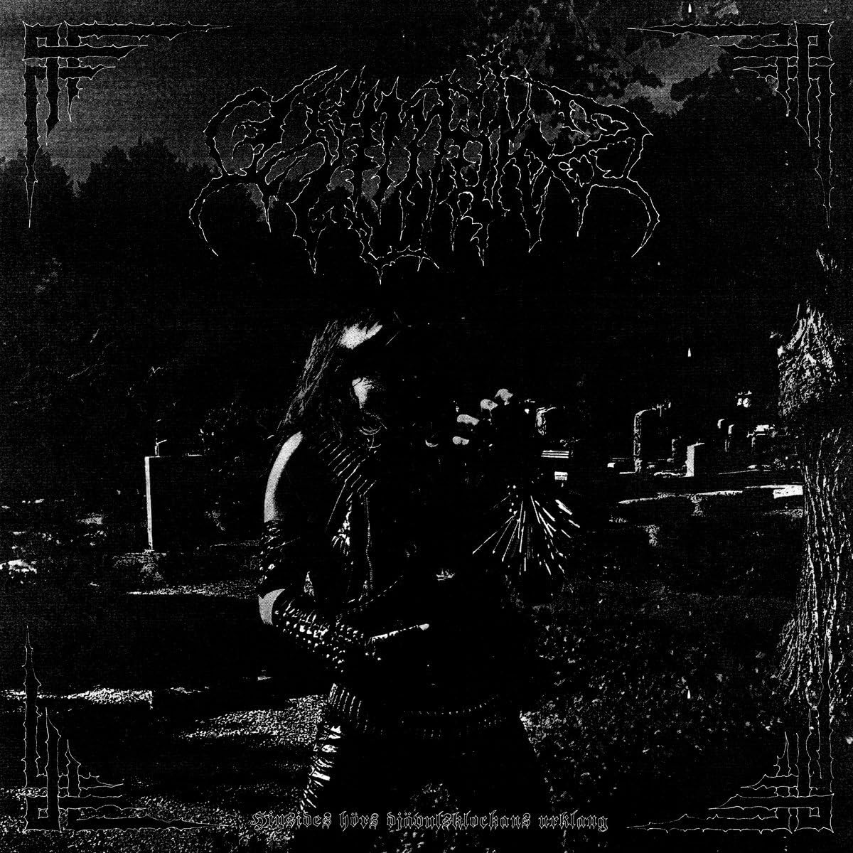 Black and white album cover depicting a graveyard and shadowy figure.