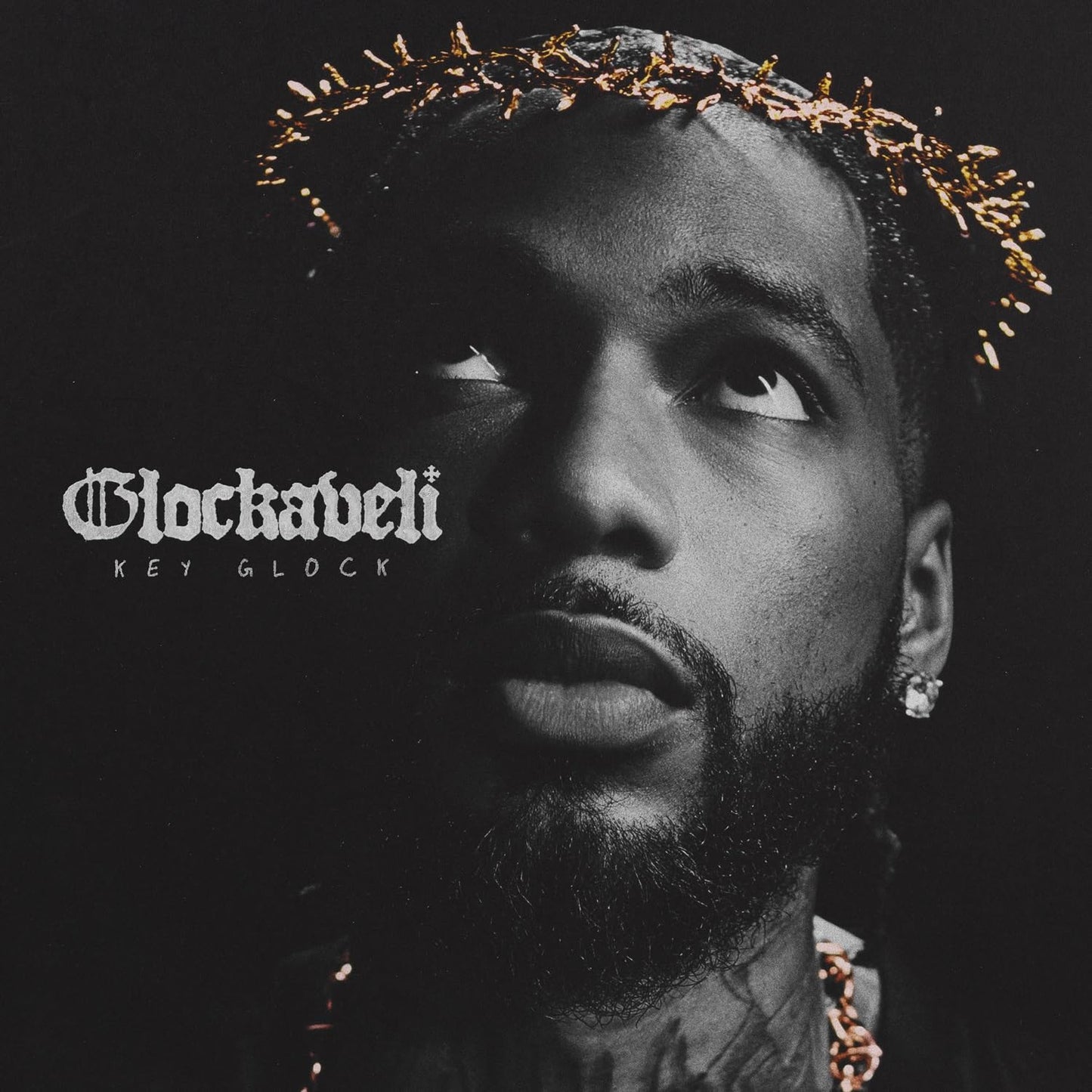 Key Glock album cover: close-up of rapper with thorn crown, dark background.
