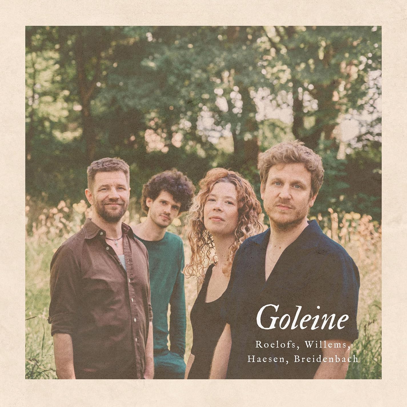 CD cover featuring a group of four people in a field.