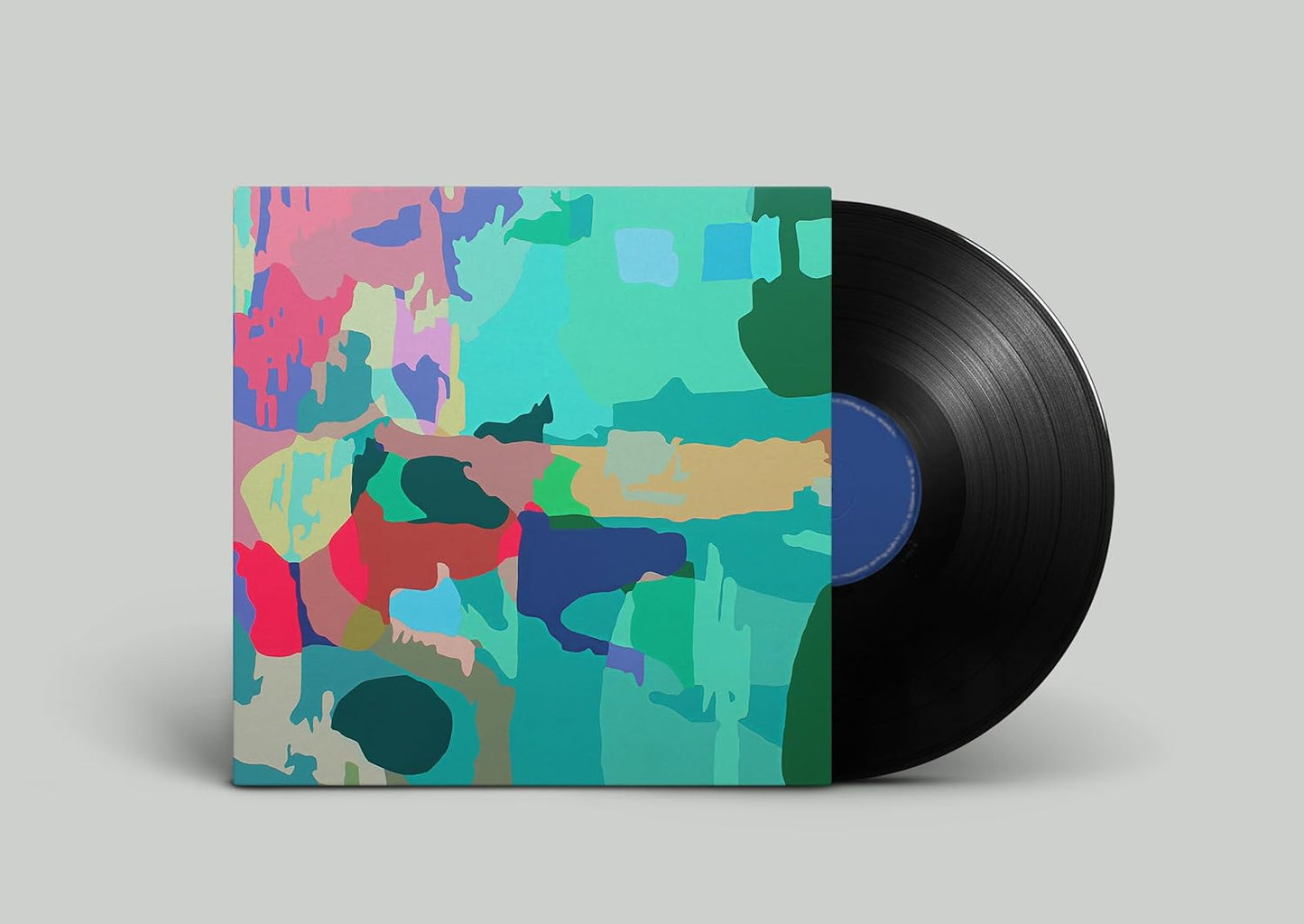 Vinyl record with colorful, abstract geometric album art.