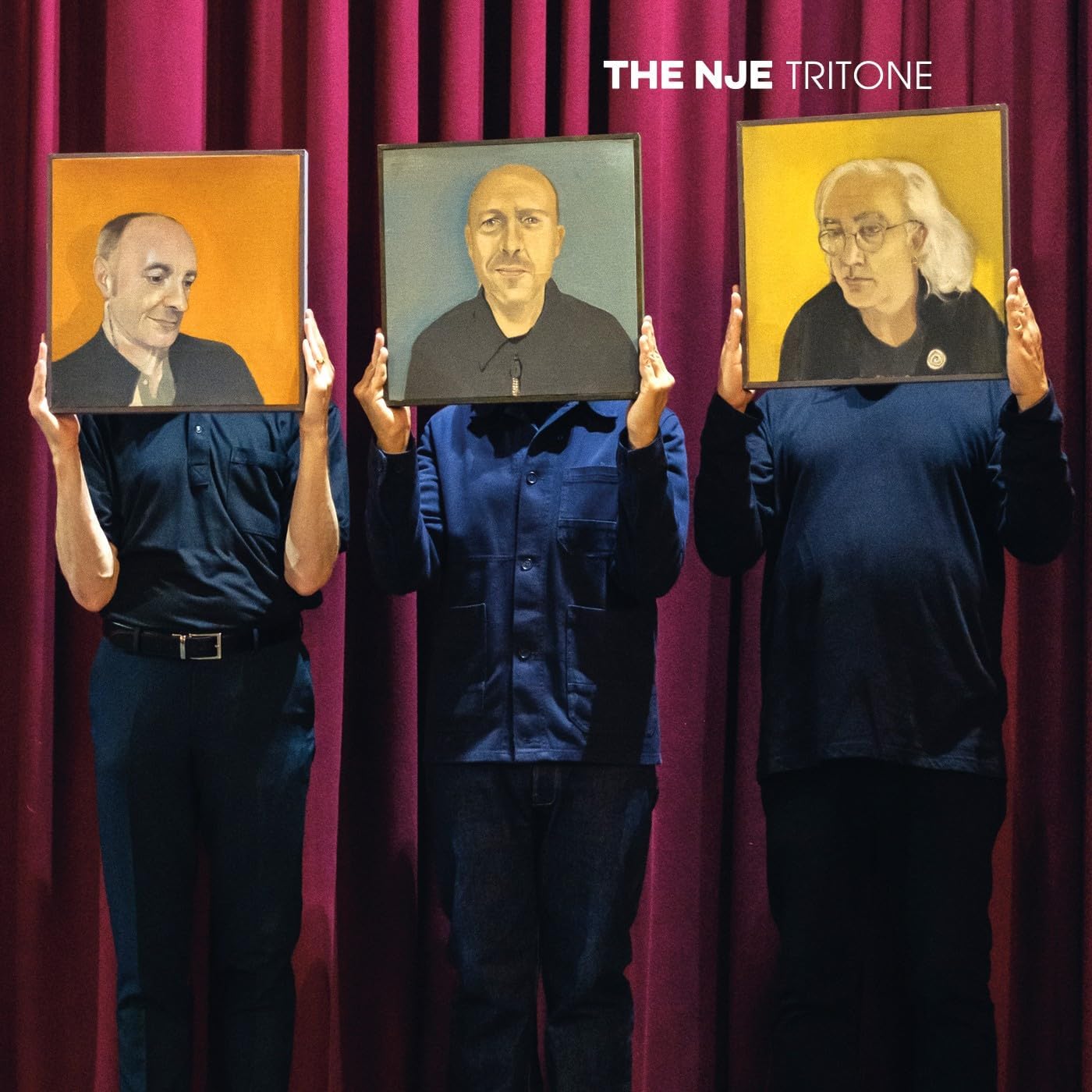 Album cover featuring three men holding portraits in front of red curtains.