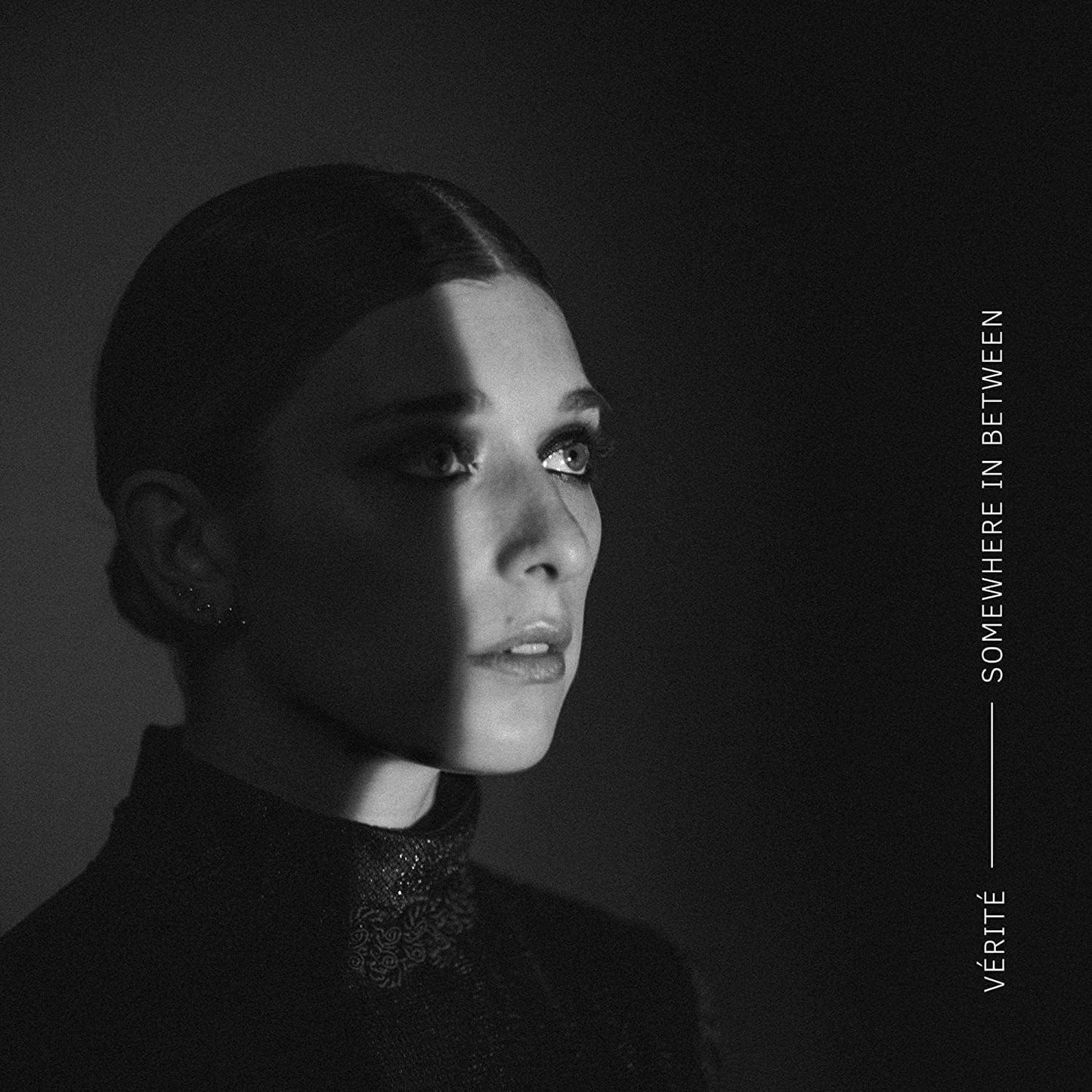 CD case for Verite’s “Somewhere In Between” album, featuring cover art.