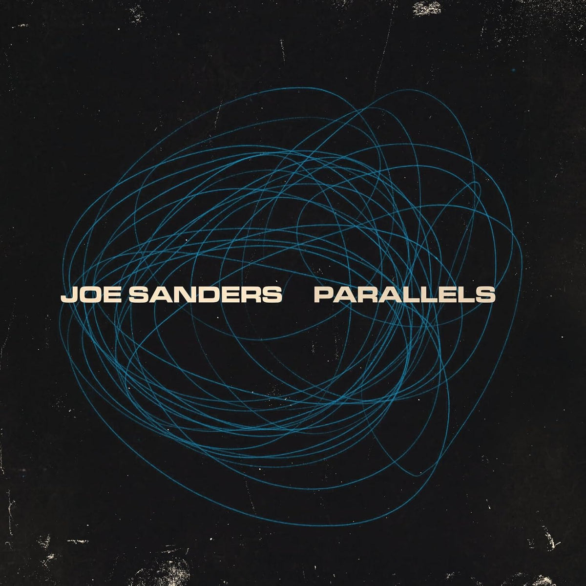 Vinyl record of Joe Sanders’ “Parallels,” black cover with white text.