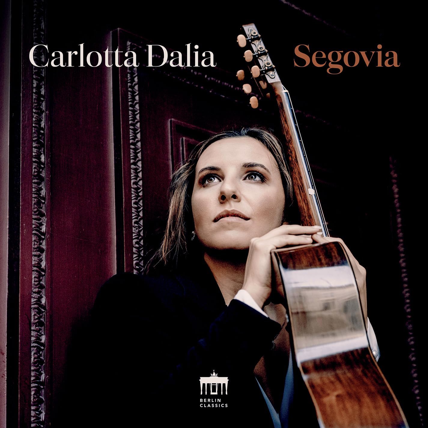 CD cover: Carlotta Dalia portrait with classical guitar, dark background.