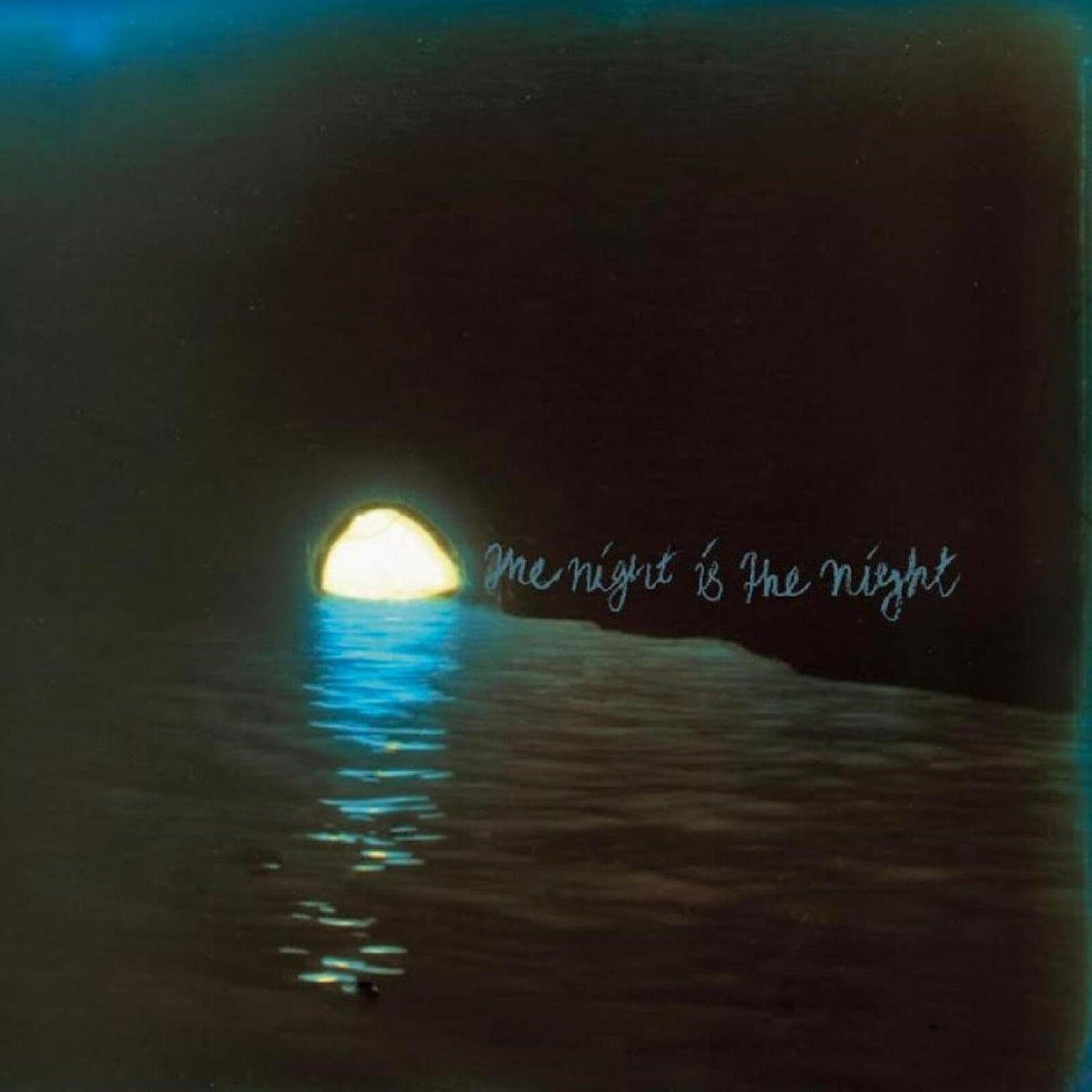 Dark album cover with a bright moon reflection and handwritten text.