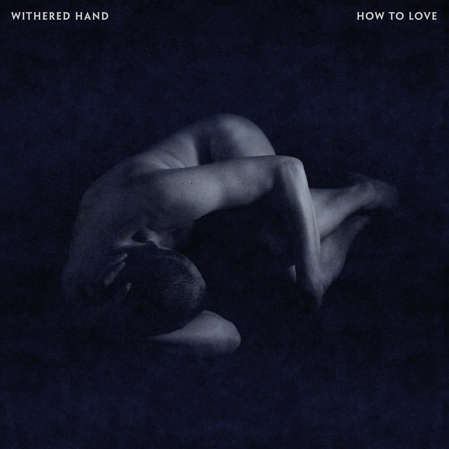 CD cover: dark, grainy image of a person curled in a fetal position.