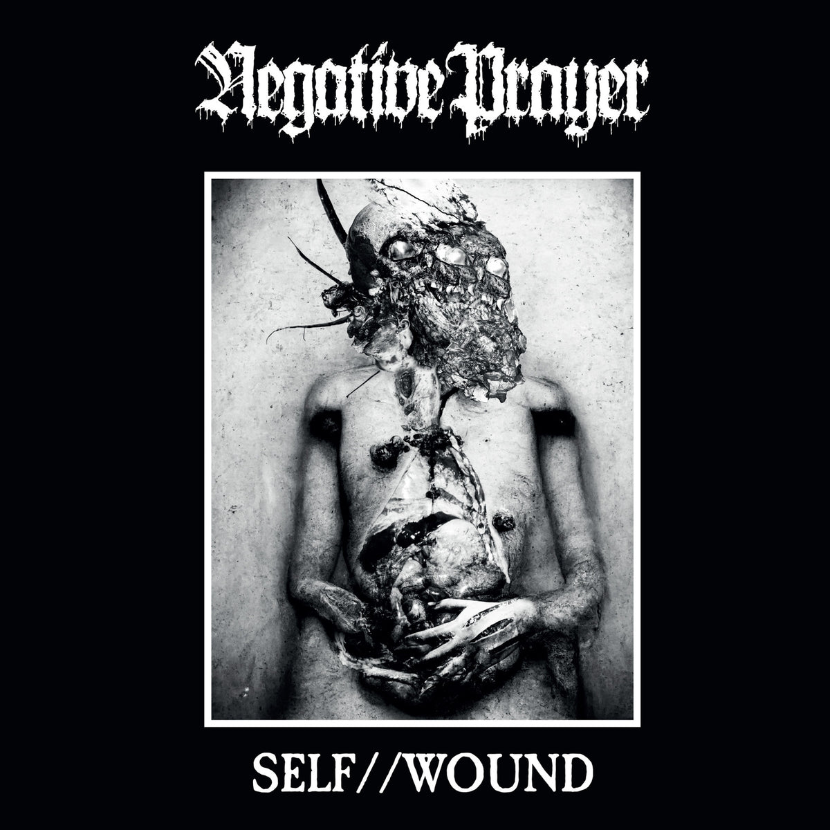 Distorted black and white image of a figure with severe bodily trauma.