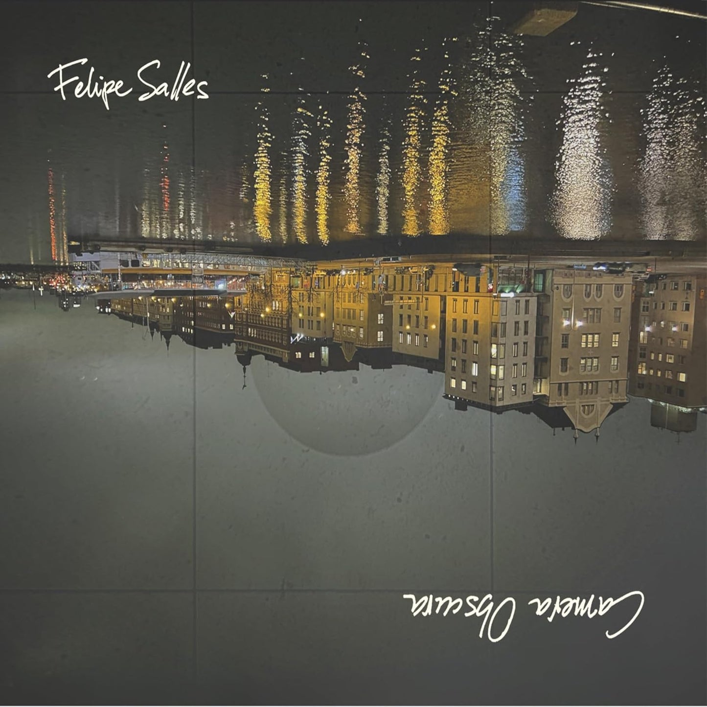 CD cover with a blurred cityscape reflected in water.