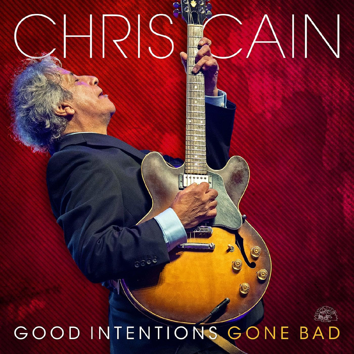 Chris Cain album cover: musician playing a brown electric guitar on red.