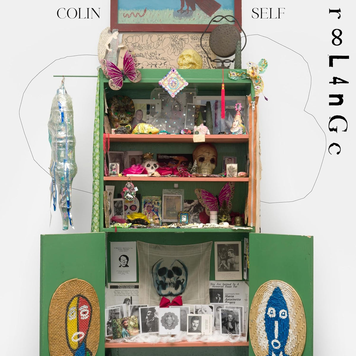 A colorful, detailed miniature room filled with objects and portraits.