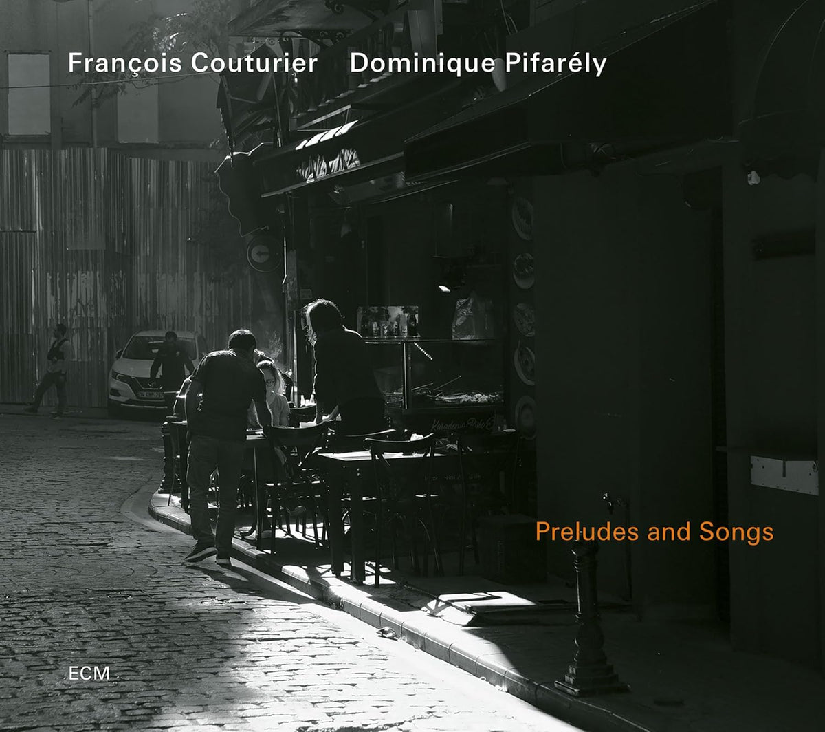 CD cover: street scene with people at a cafe, warm lighting.