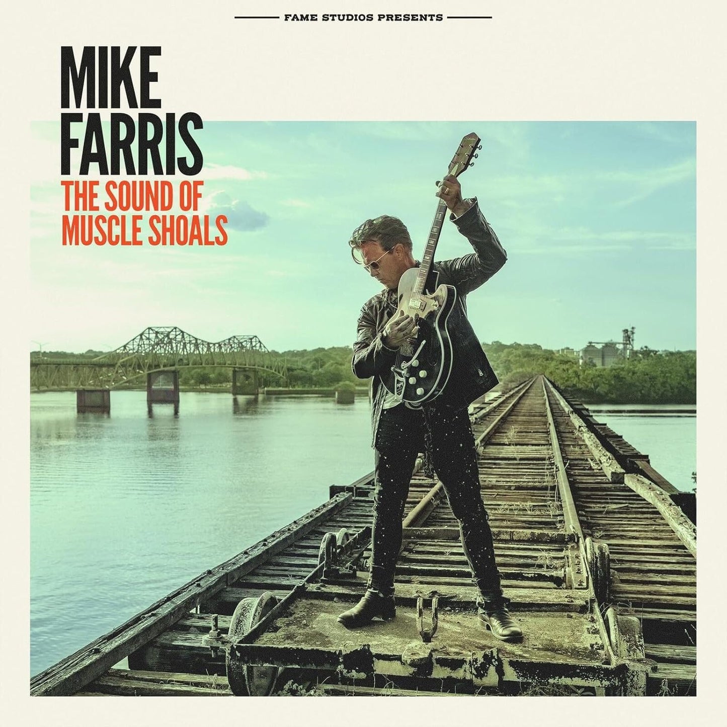 Album cover featuring Mike Farris with a guitar on railroad tracks.