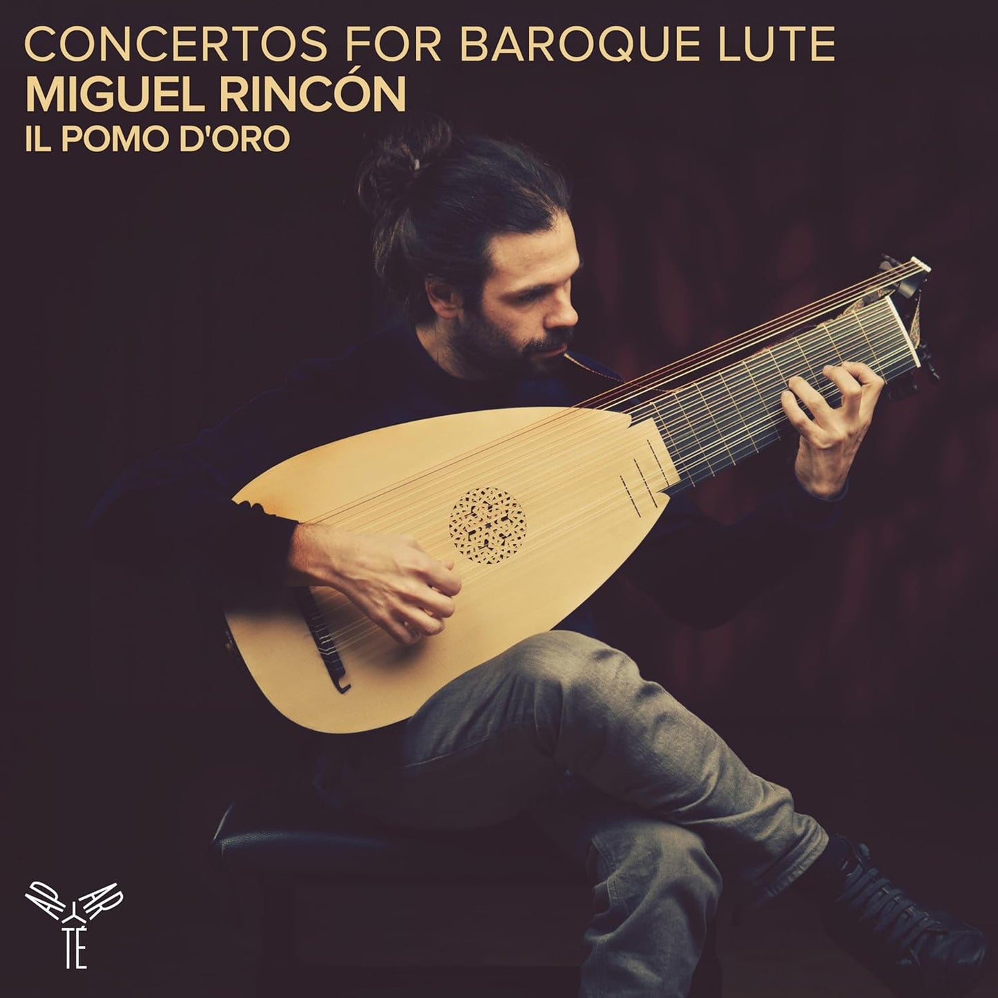 Man playing a detailed, light-wood baroque lute against a dark background.