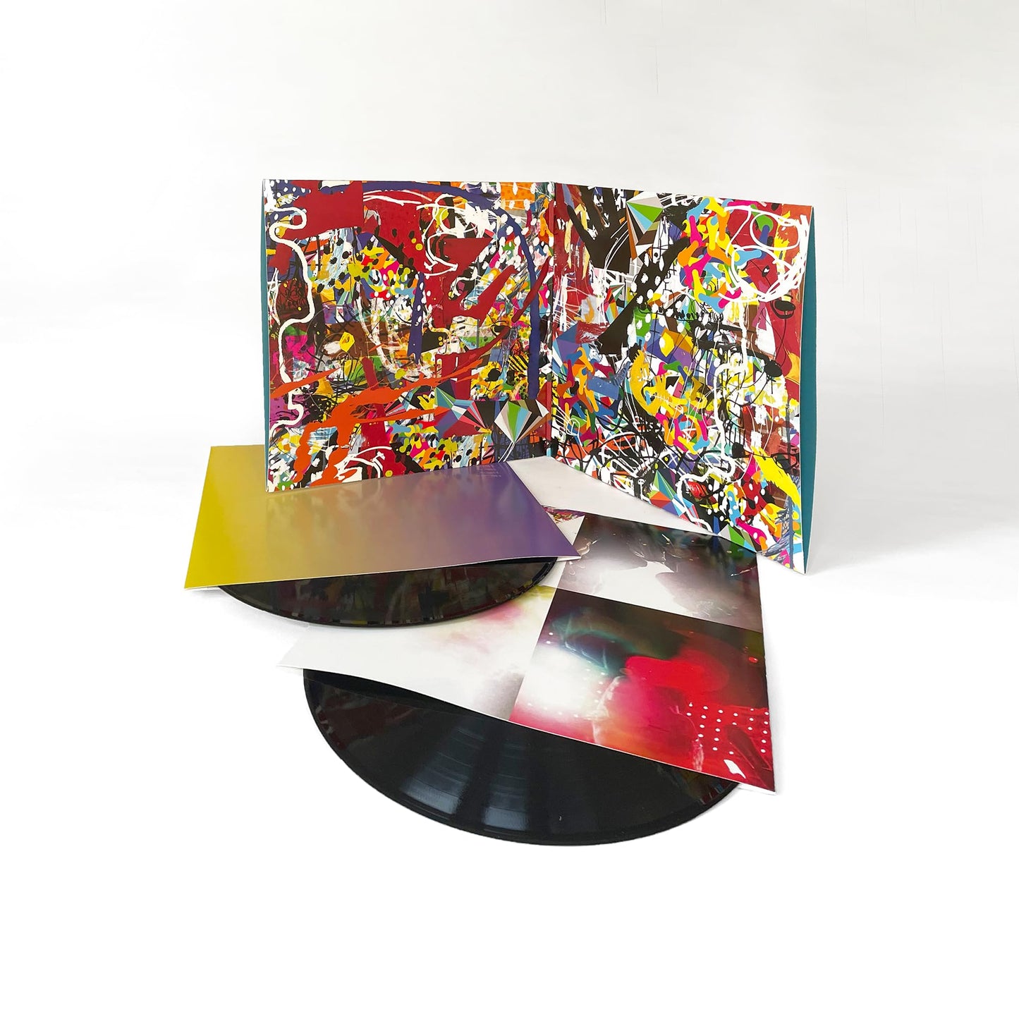 Vinyl record and open gatefold sleeve with colorful, abstract artwork.