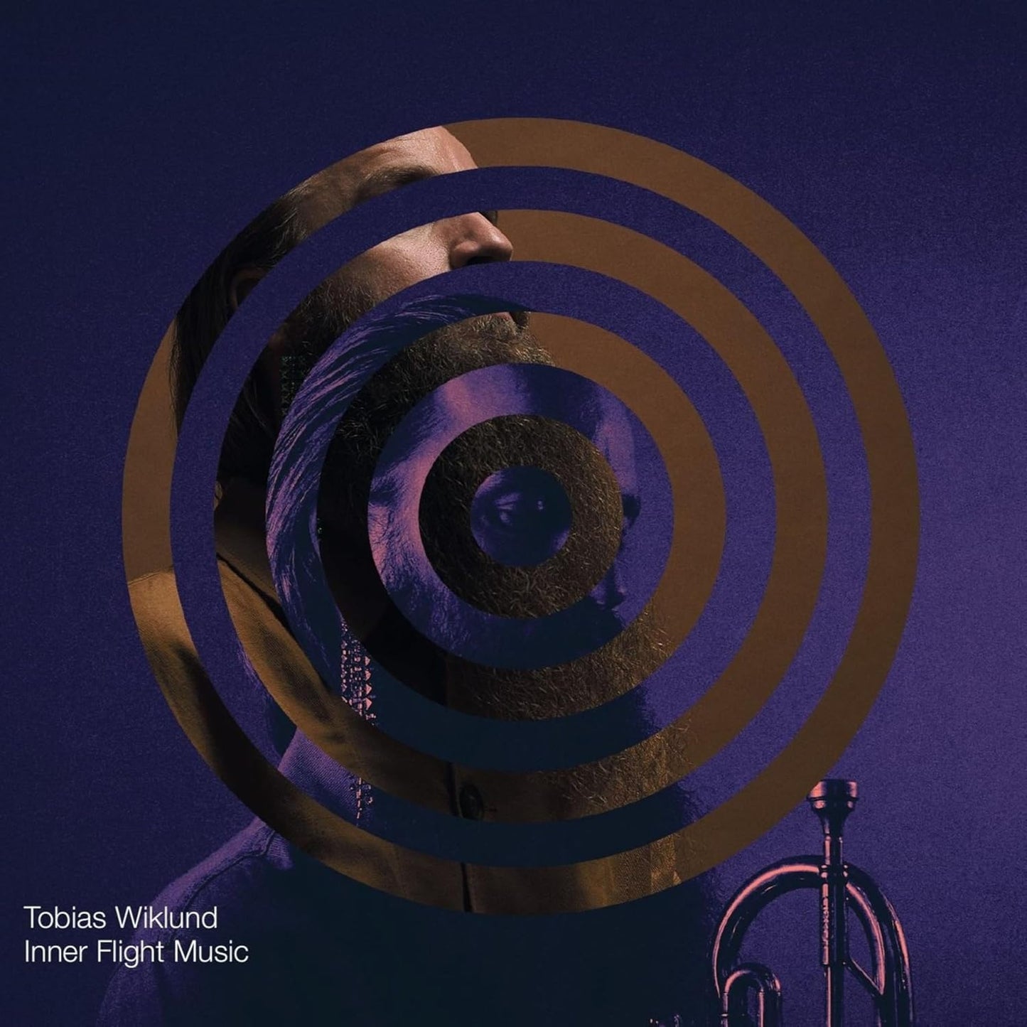 CD cover with distorted portrait of a man and concentric circles.