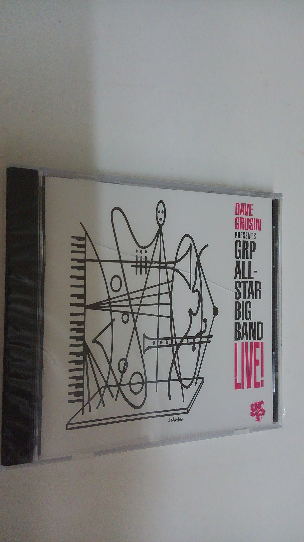 CD case with abstract white line art and red text: "GRP All Star Big Band Live!".