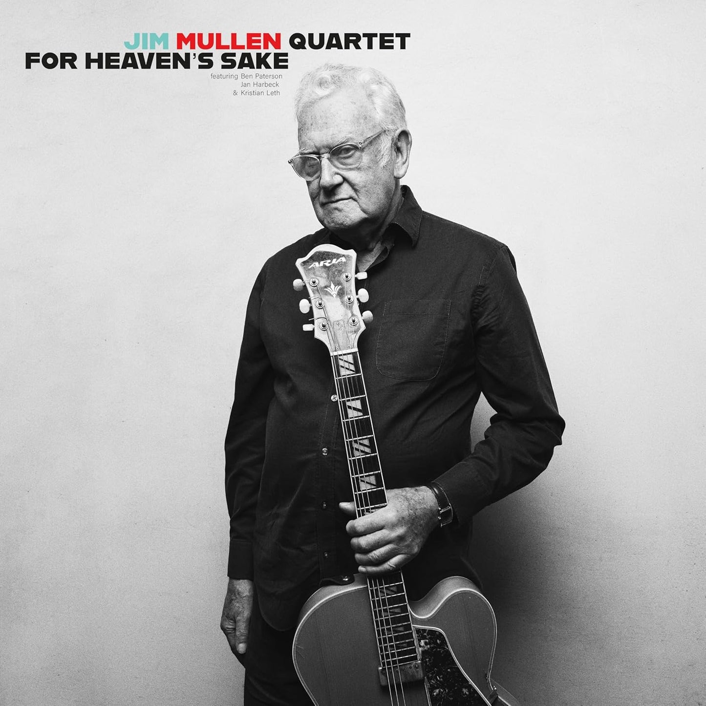 Black and white portrait of jazz guitarist Jim Mullen holding his instrument.