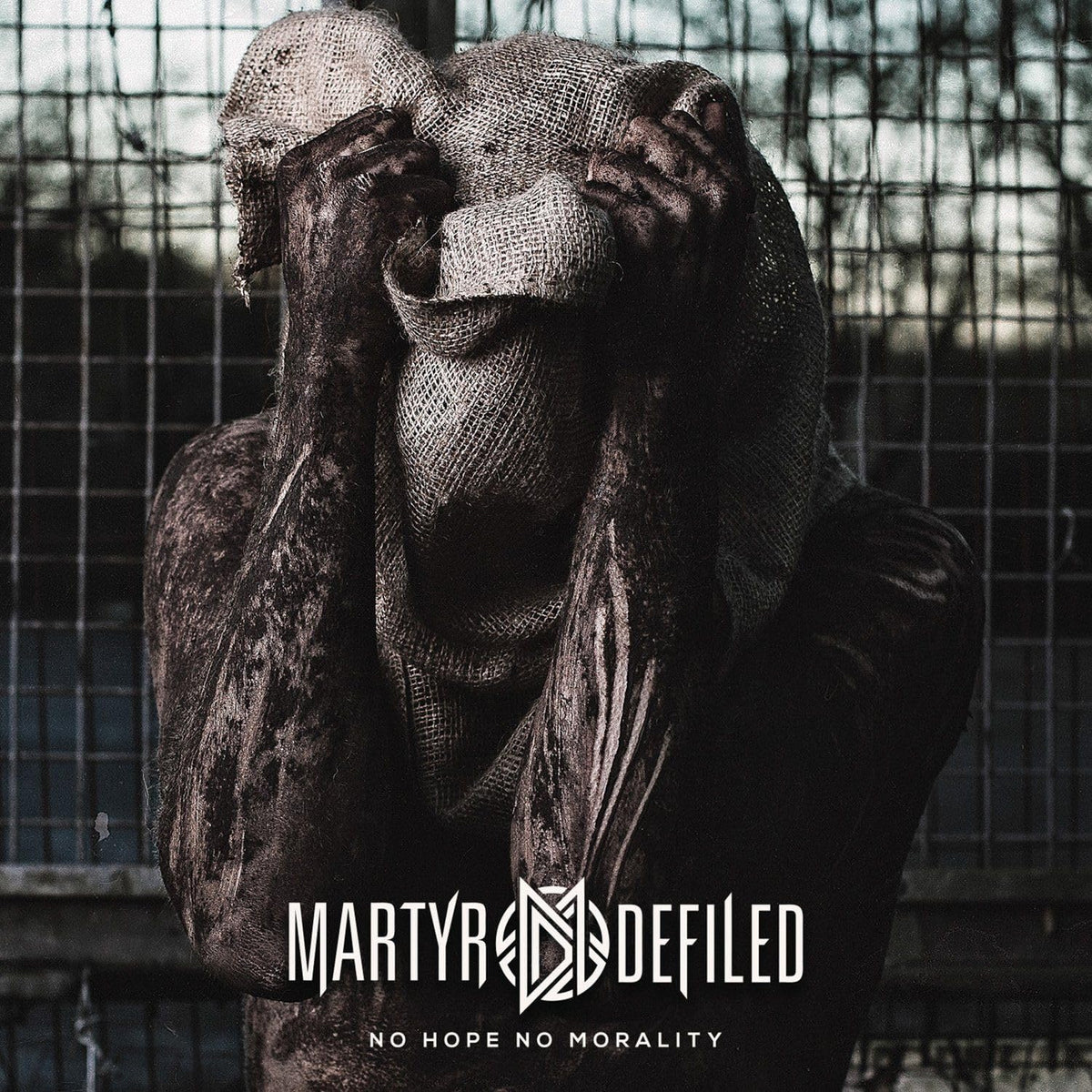 Gorilla sculpture with head in hands, dark and gritty, album cover.