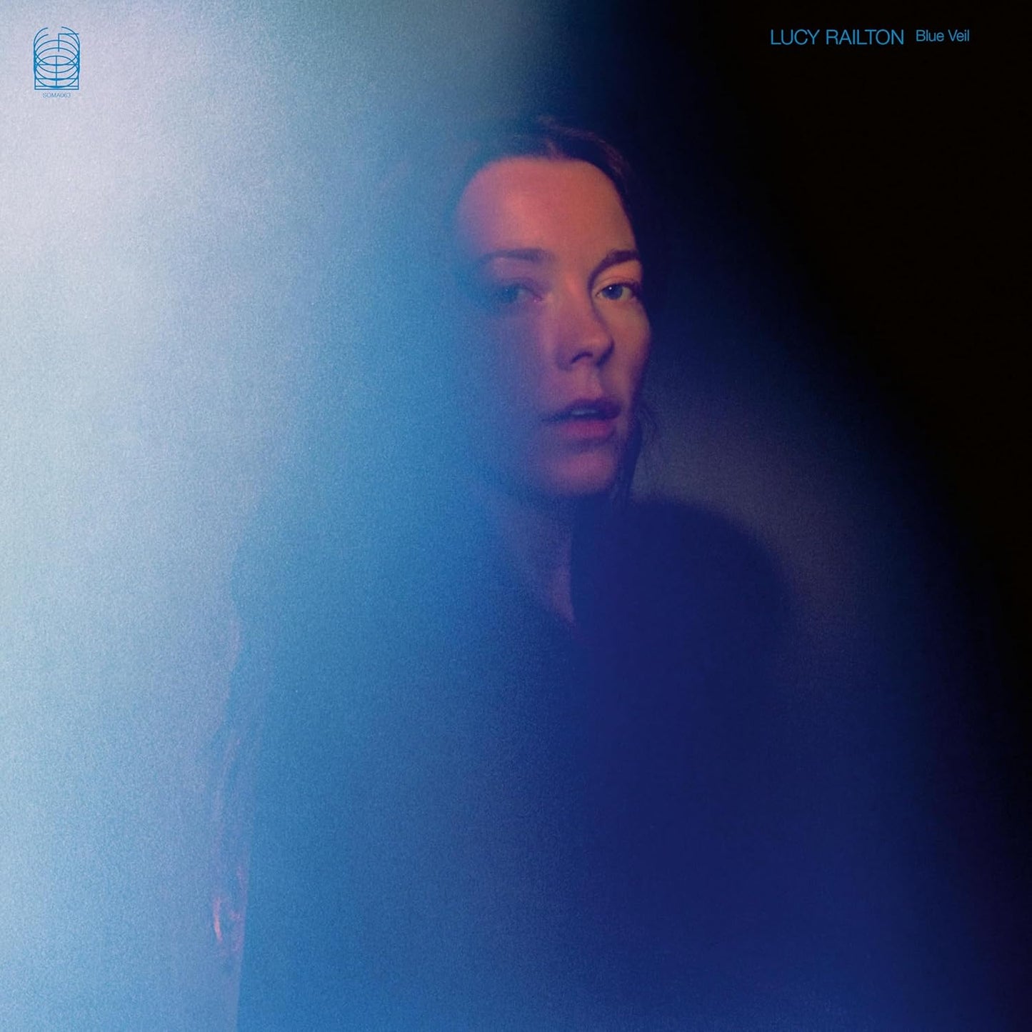 Portrait of Lucy Railton against a blurred blue and black background.