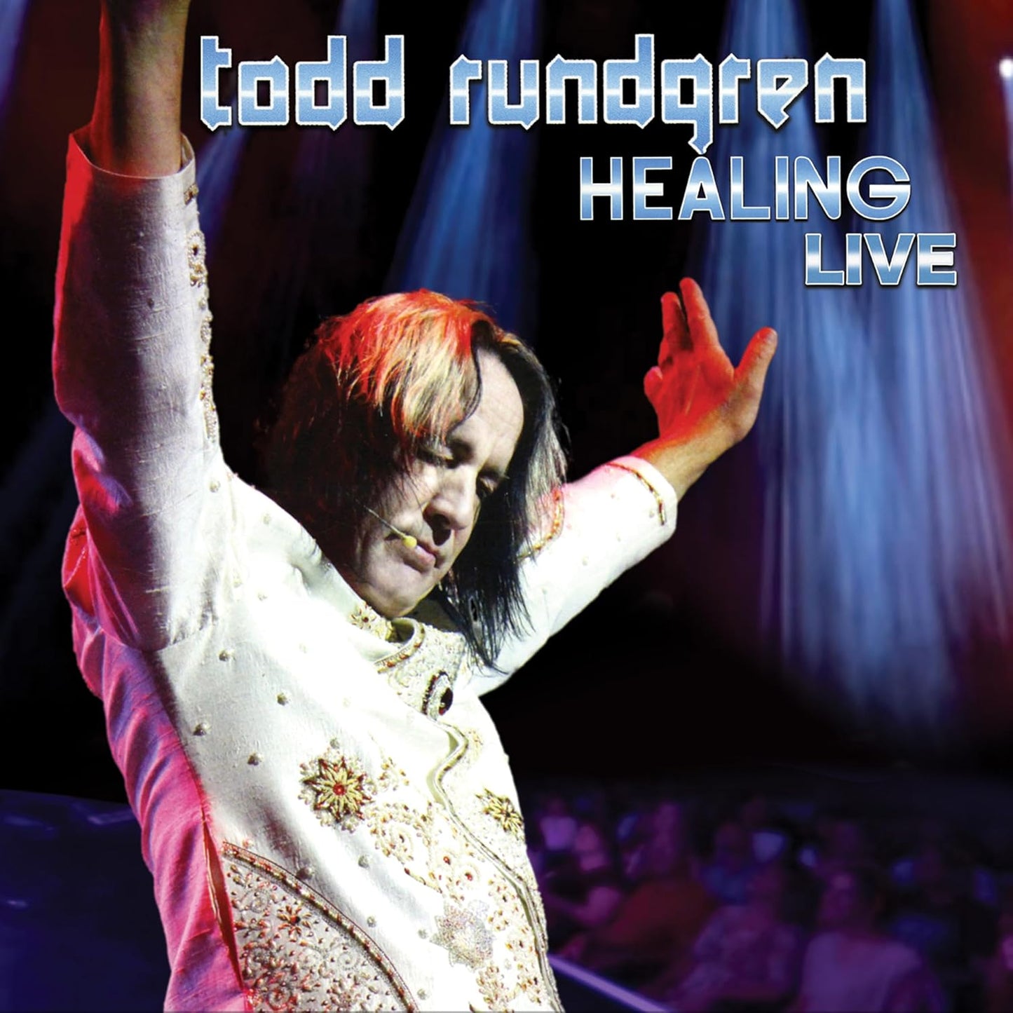 Todd Rundgren on stage with arms raised, "Healing Live" Blu-ray cover.
