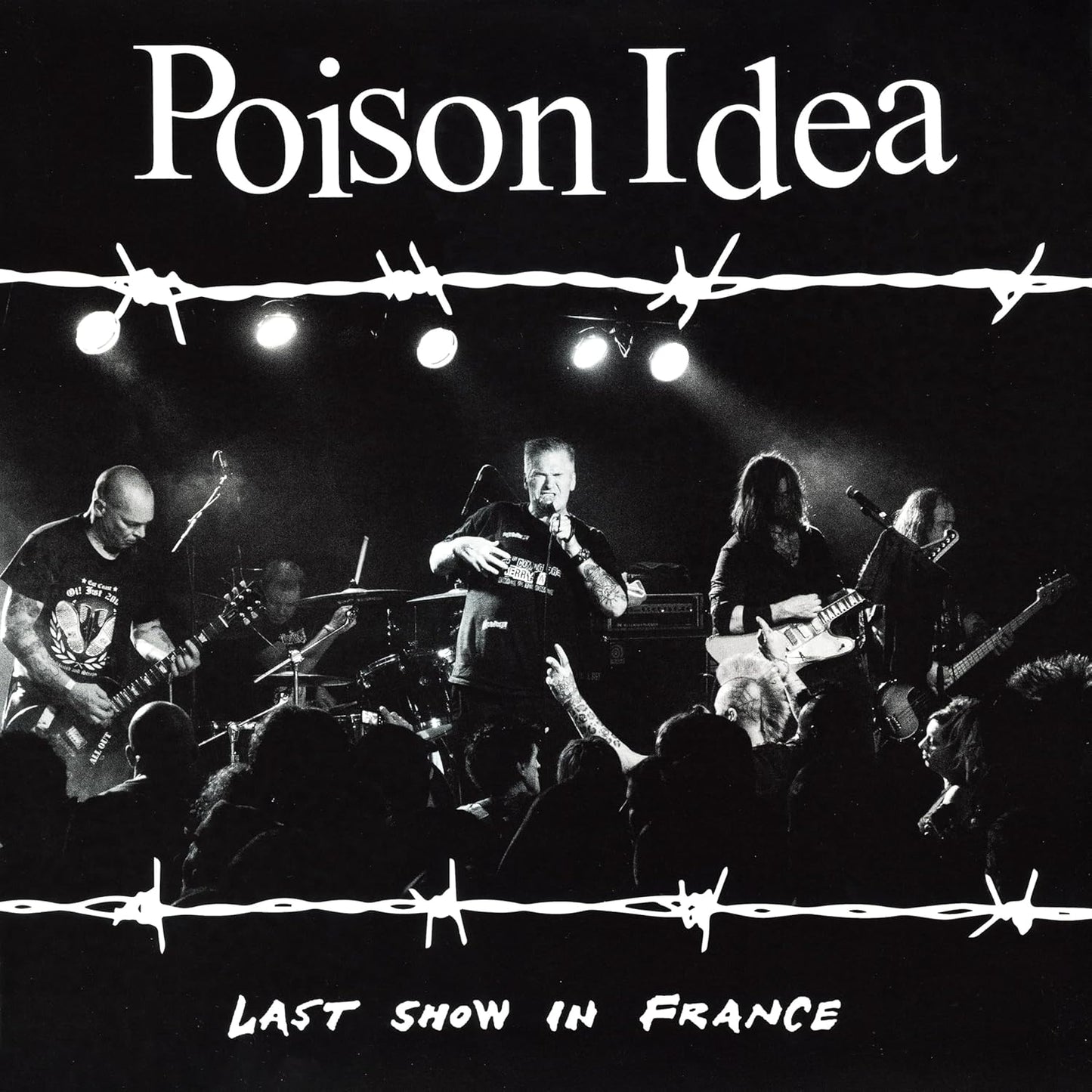 Black and white photo of a punk band, Poison Idea, performing live.