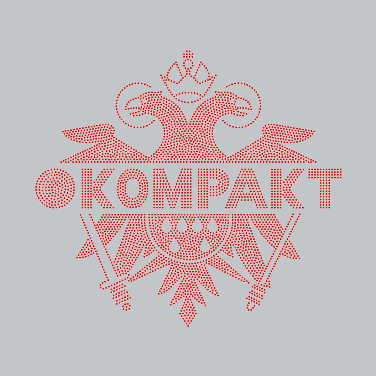 Red dotted floral design with “KOMPAKT” text on a gray background.