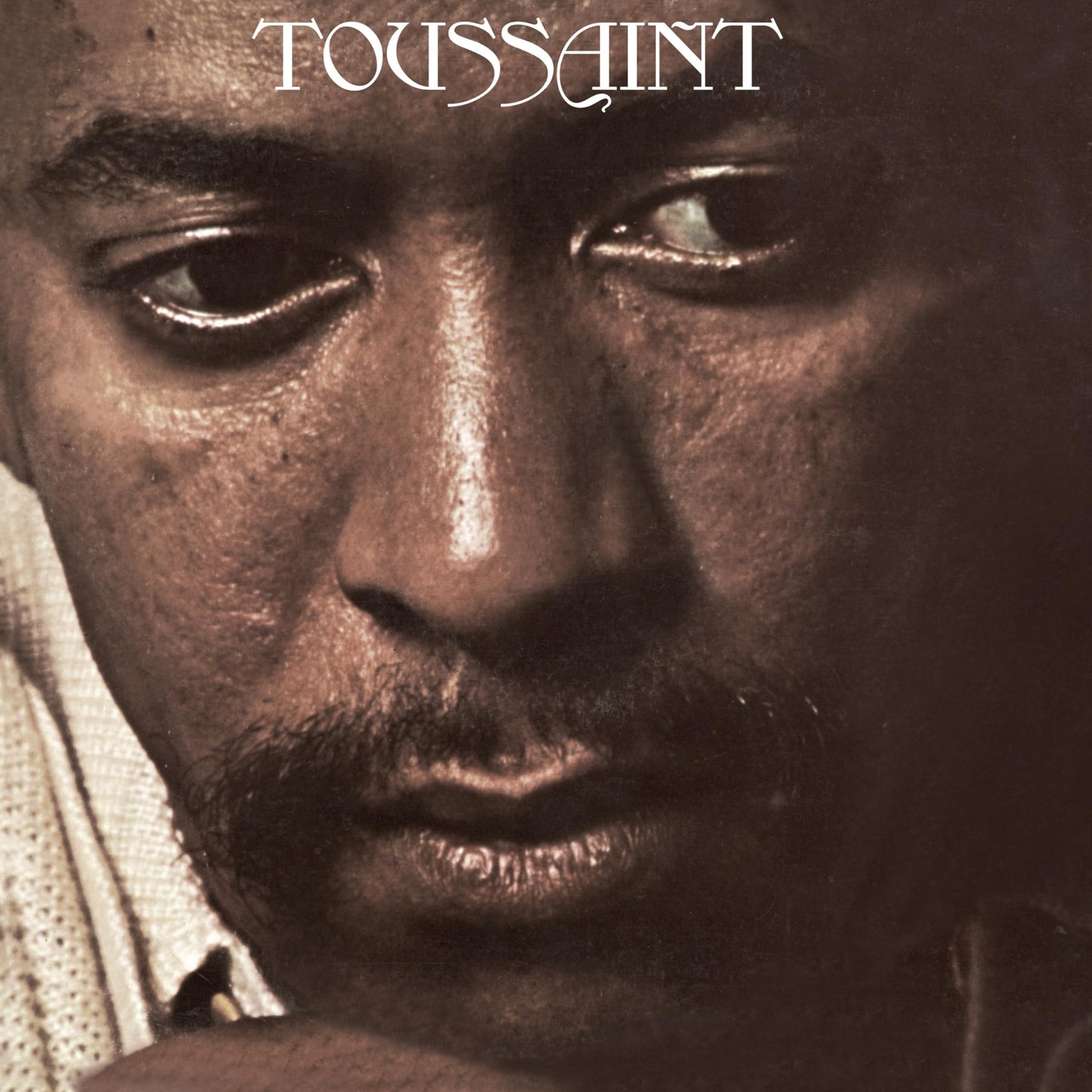 Close-up portrait of Allen Toussaint with the album title above.