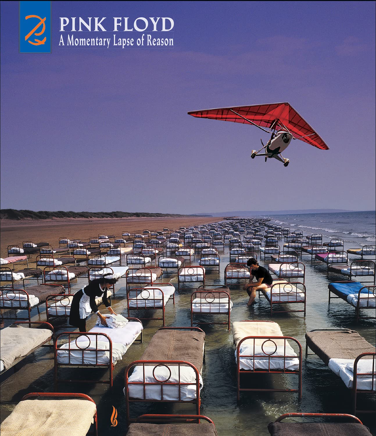 Album cover: beach with beds, a glider, and people in the water.