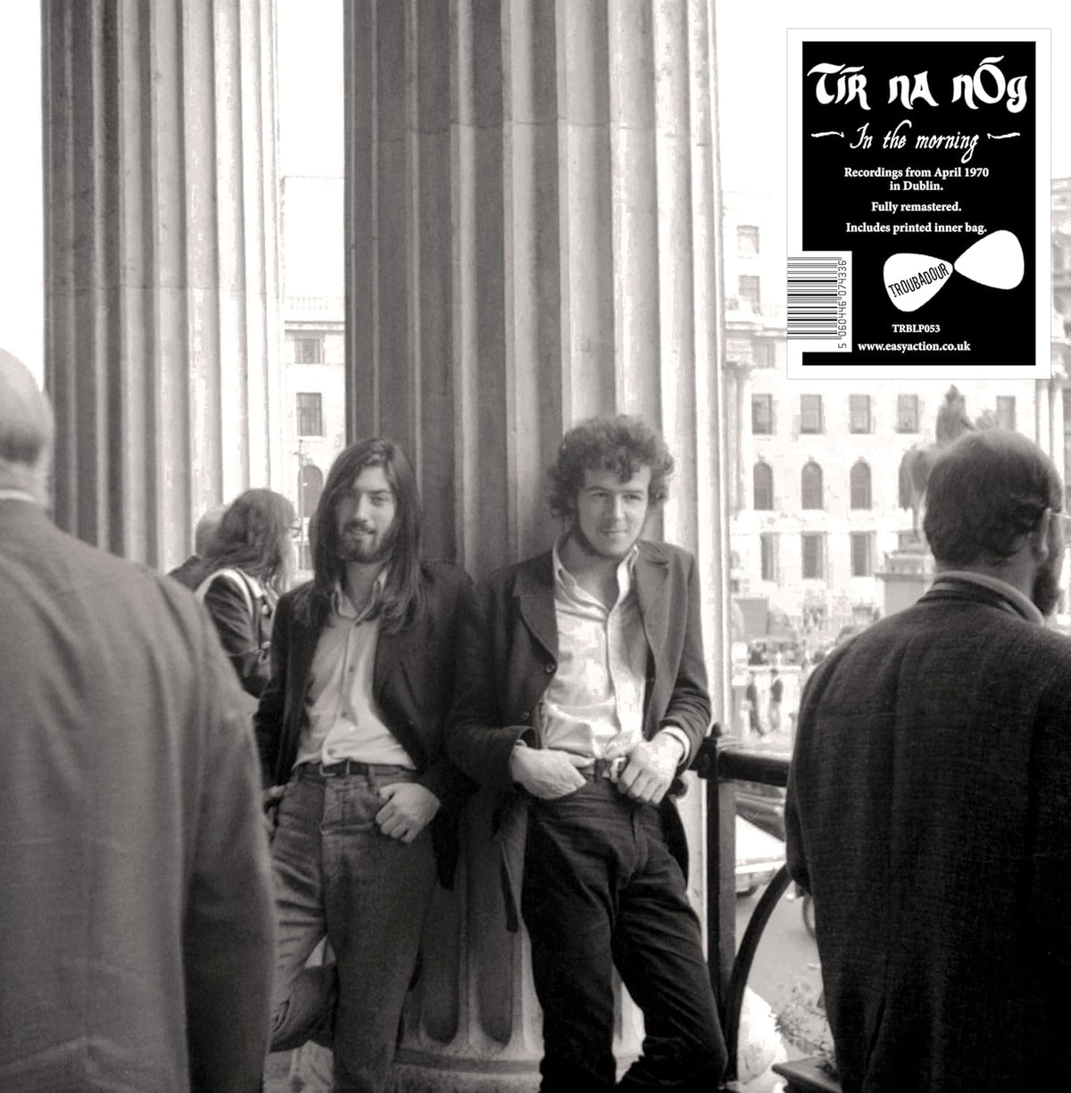 Black and white vinyl record cover featuring a group of men outdoors.