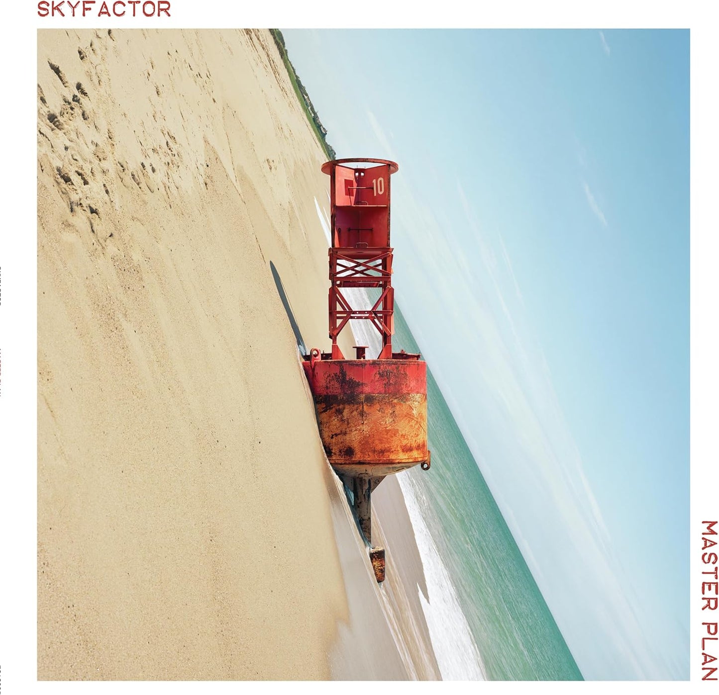 Skyfactor’s “Master Plan” vinyl cover: aerial view of a red buoy on sand.