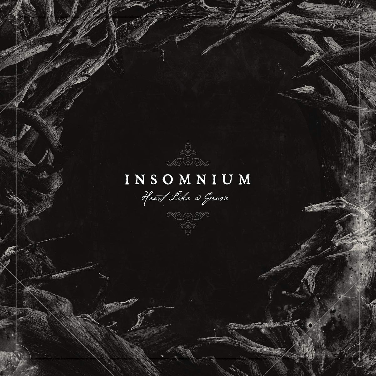 Black and white album cover for Insomnium’s “Heart Like a Grave” with branch imagery.