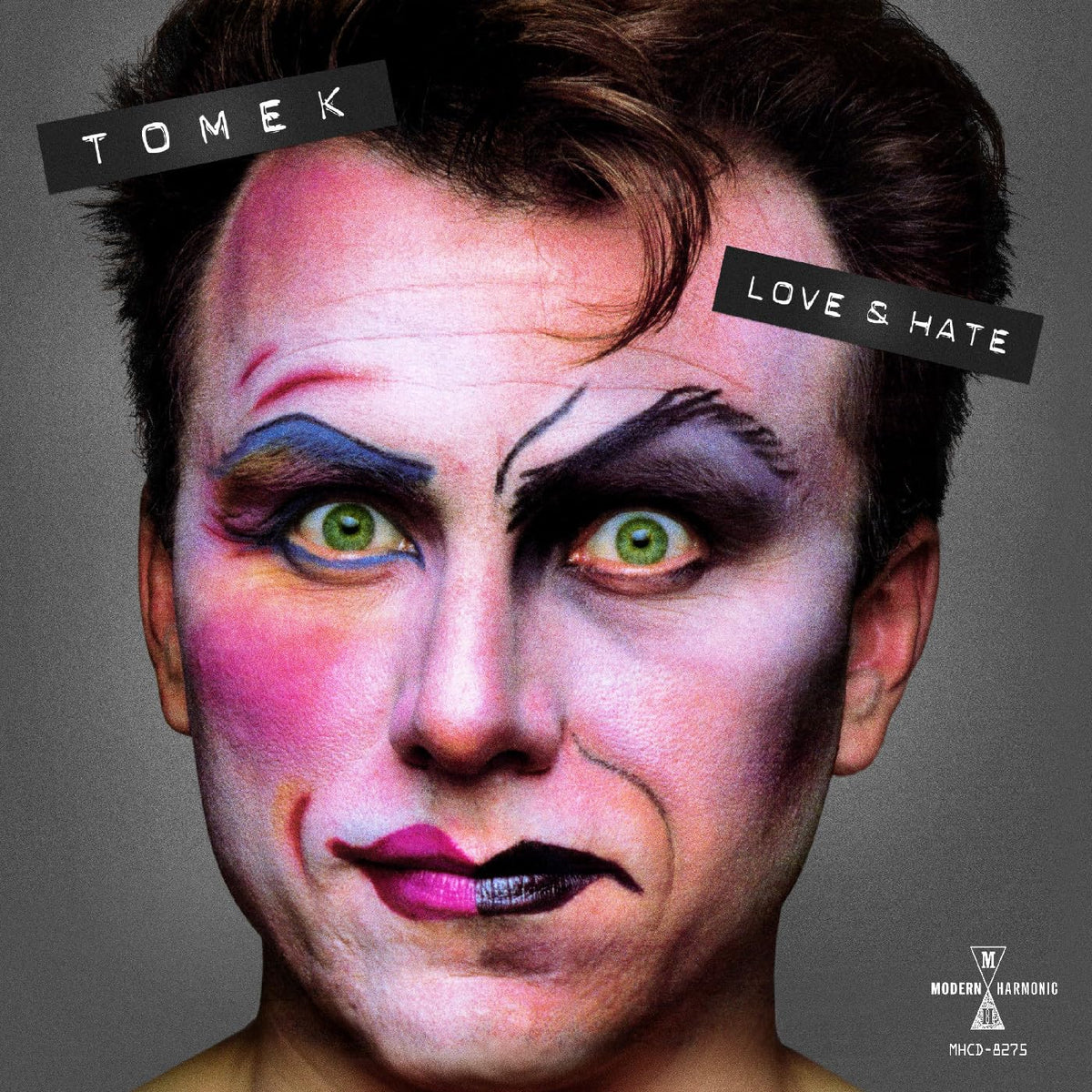 CD cover: split-face portrait of Tomek, with colorful makeup and text.
