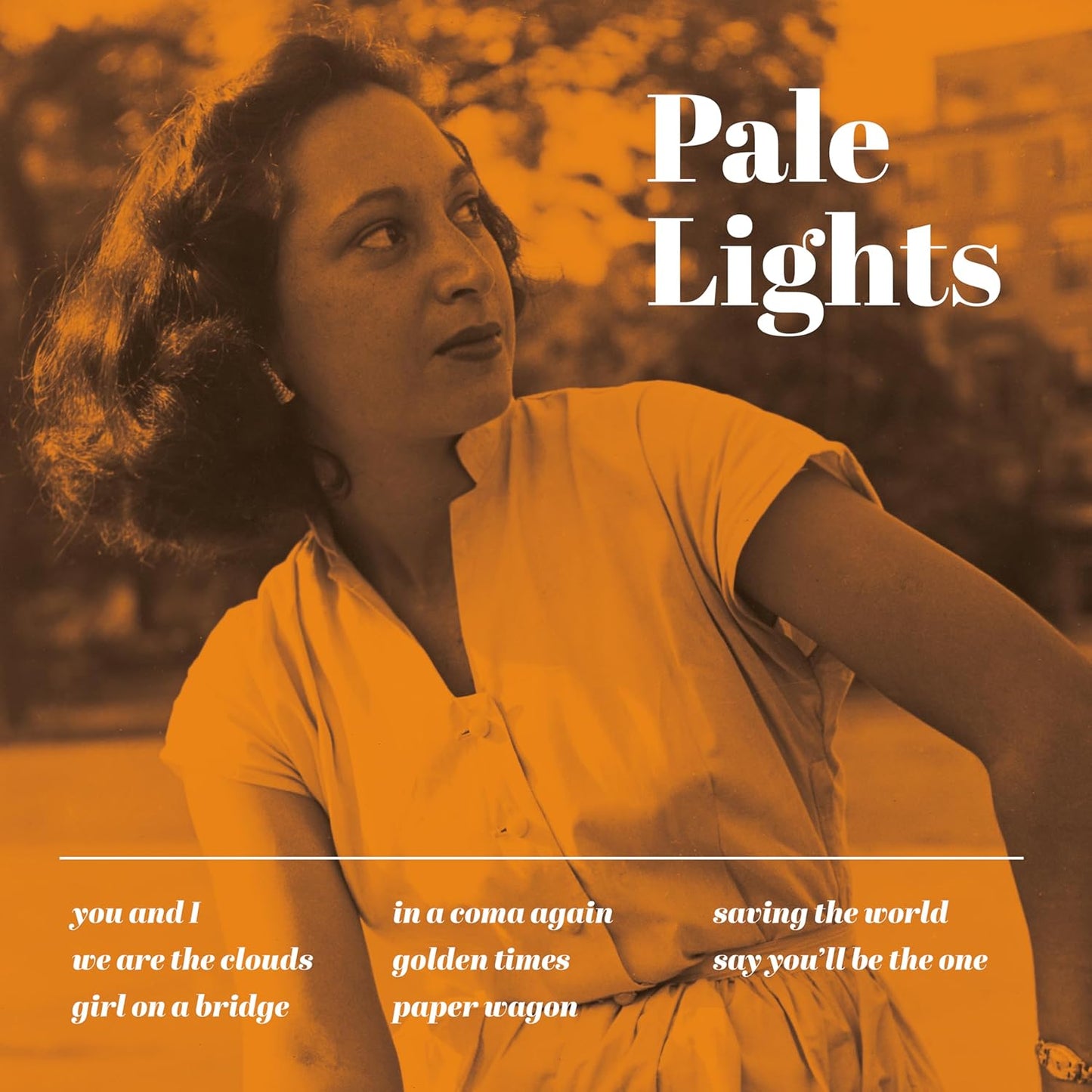 Album cover for Pale Lights, featuring a woman looking upwards in orange tones.