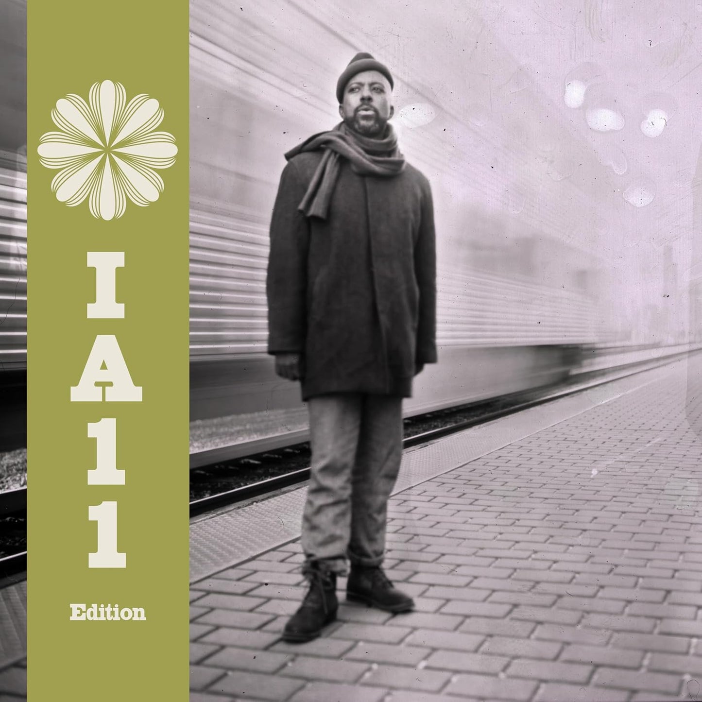 Album cover featuring a man standing on a subway platform.