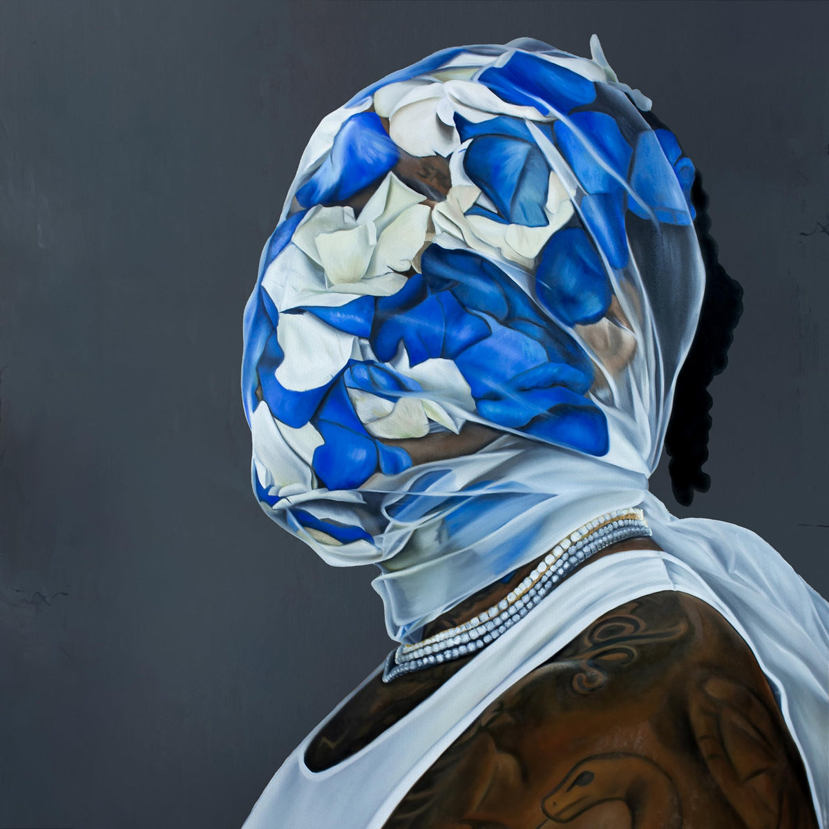 Portrait of Gunna with face obscured by blue and white fabric.