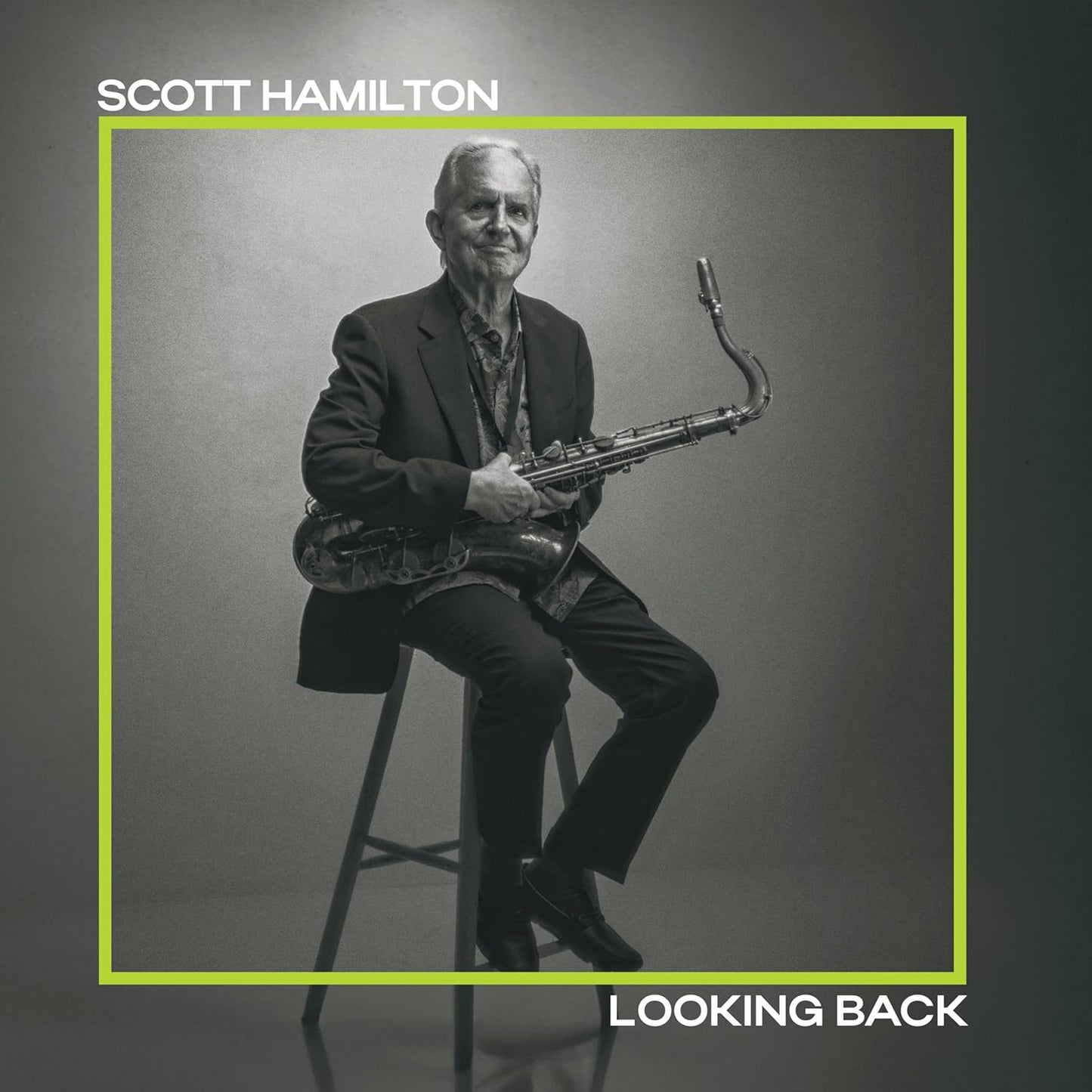 Scott Hamilton, a saxophonist, seated with his instrument, album cover.