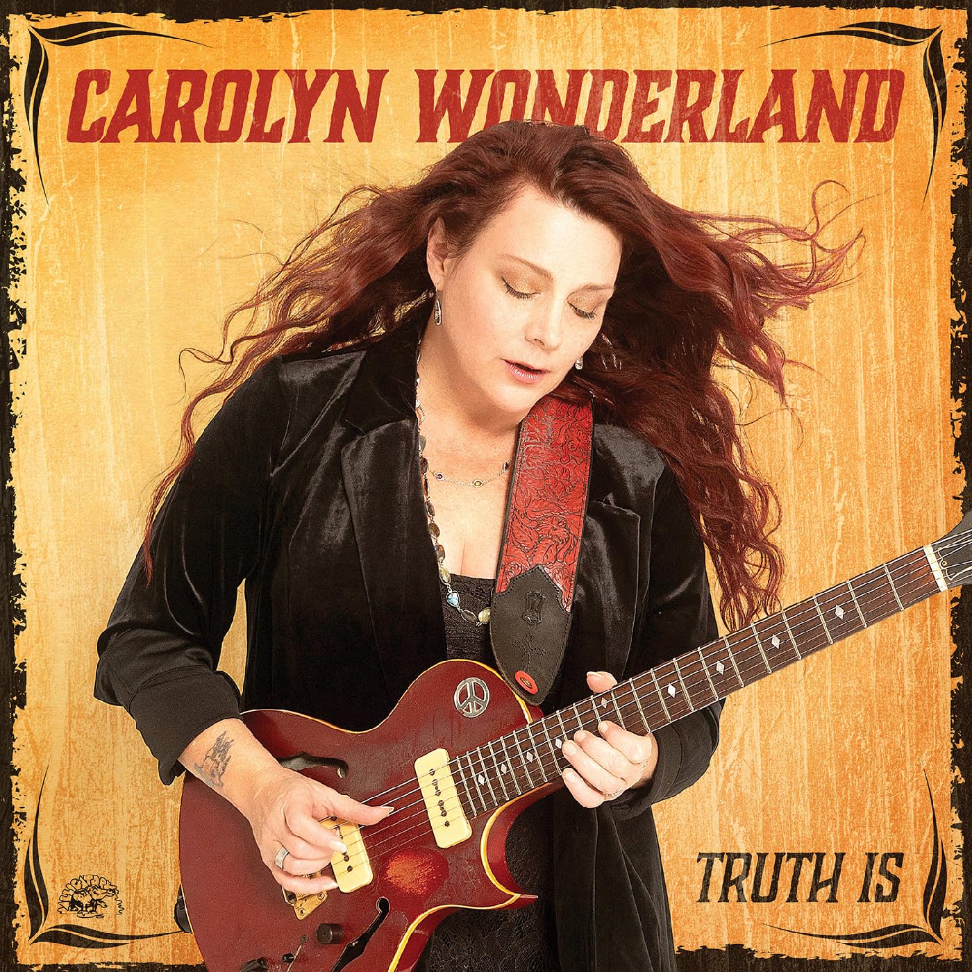 Carolyn Wonderland album cover, woman playing a sunburst electric guitar.
