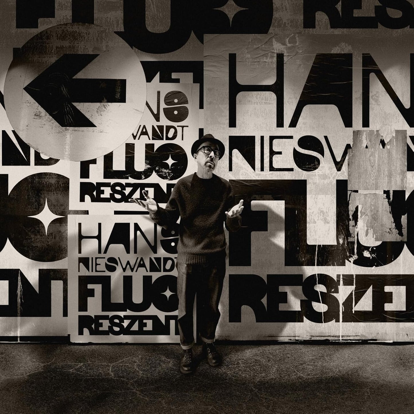Man in front of a wall covered in fragmented text and images.