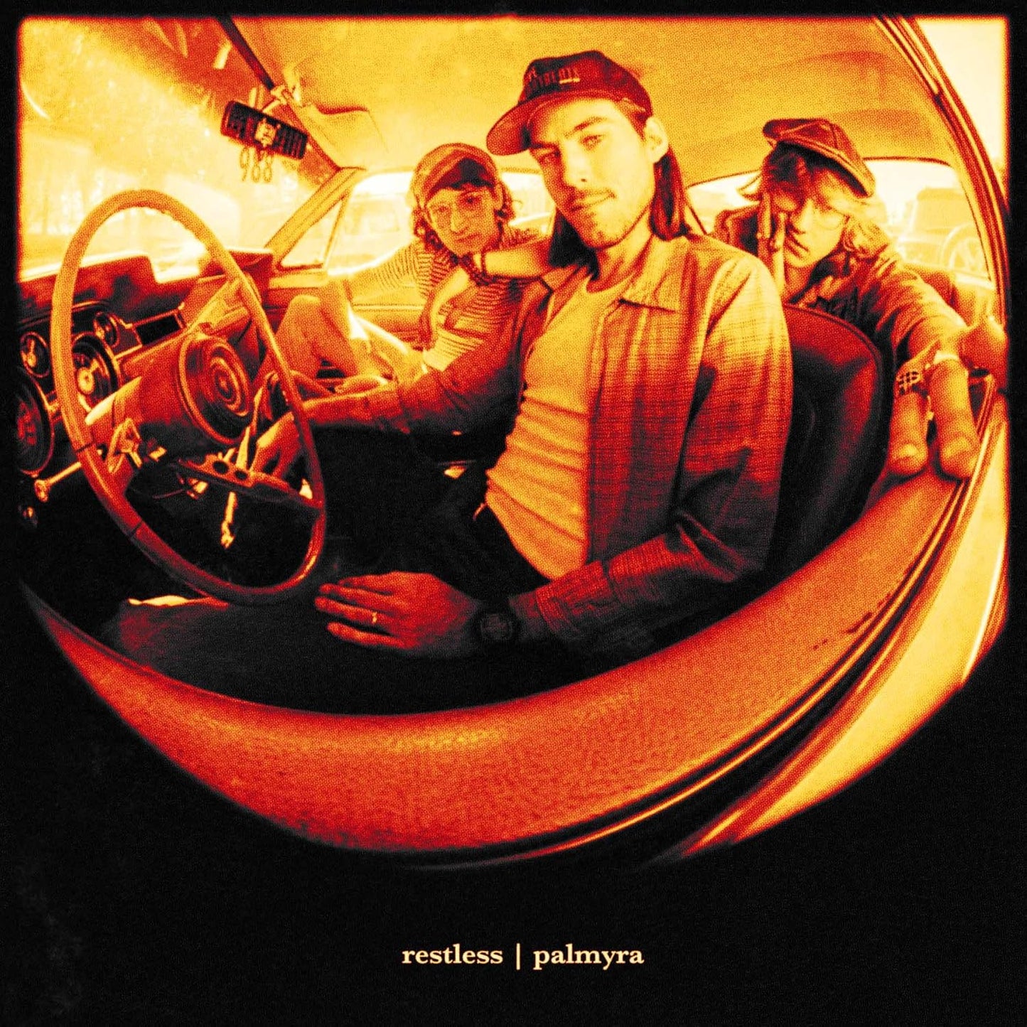 CD cover: three people inside a vintage car, warm tones.