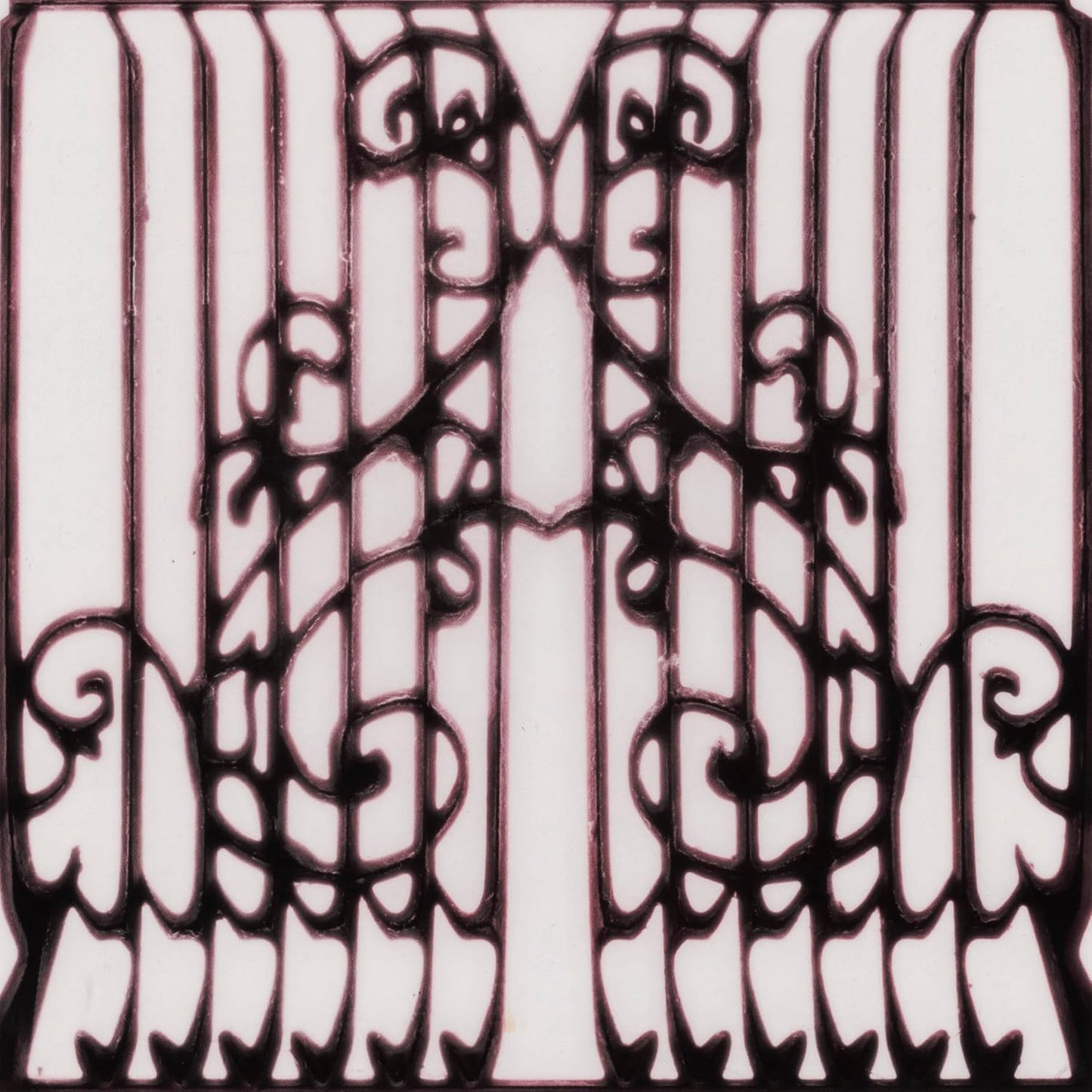 Symmetrical black ornate iron gate pattern on a white background.