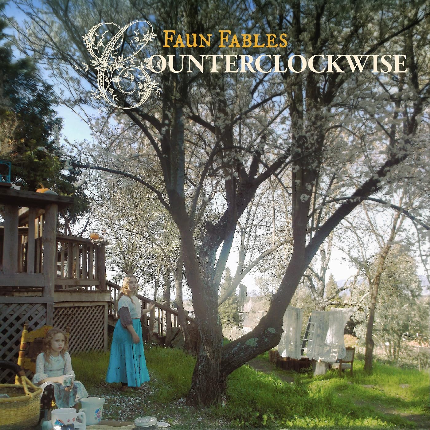 Album cover: two figures in a garden with a large tree.