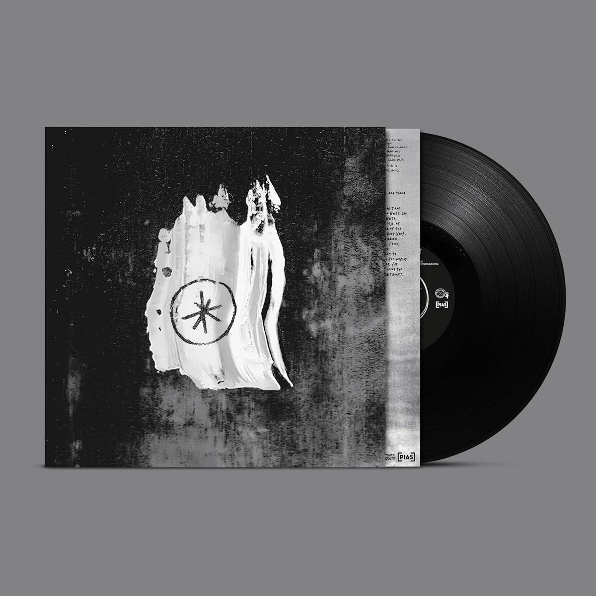 Black vinyl record with a ghostly figure and floral design on the cover.