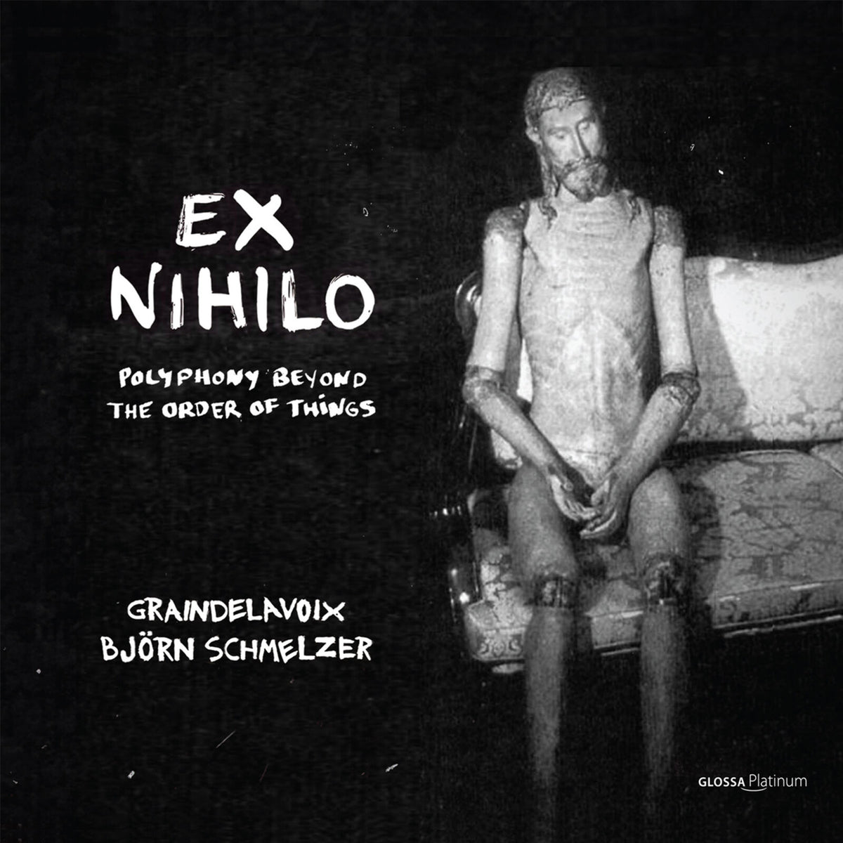 Black and white CD cover featuring a carved wooden figure with text.